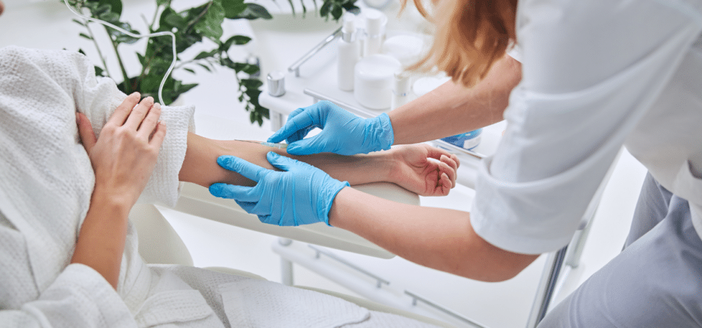 Nurse giving an IV in a bright modern setting - Growth Marketing
