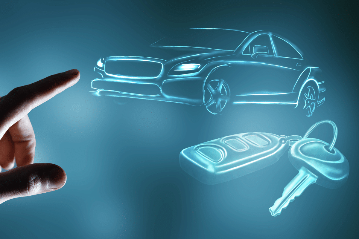 Finger pointing of a car and keys sketched on a glowing screen - social media marketing