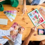a table with different hands and materials in a flat lay shot where marketers execute digital marketing trends 2026 strategies